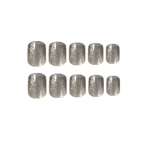 Set of 10 short silver cat eye press-on nails with metallic glitter finish on white background