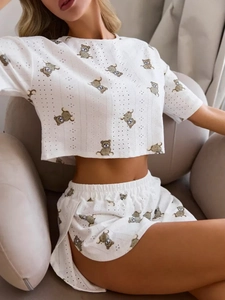 Close-up of pointelle knit fabric texture and cute brown bear patterns on summer pajamas
