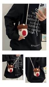 Detail view of mini knit mushroom crossbody bag with brown roof and creamy white body