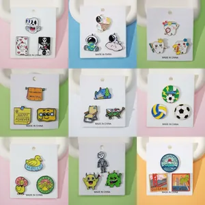 Creative enamel pins set featuring astronaut, pets, and landscapes on display cards