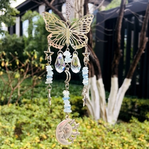 Detailed view of butterfly suncatcher with crystal beads and crescent moon charms