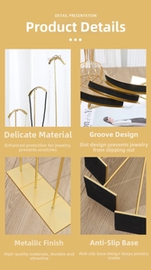 Detail view of gold metal necklace stand showing non-slip base and curved hook with pads