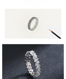 Macro view of baguette and round-cut zirconia eternity ring with design inspiration sketch