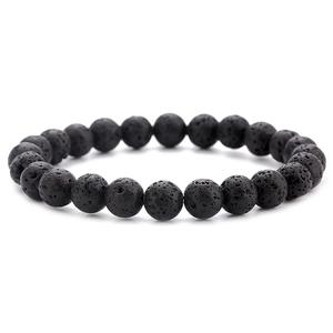 Detailed view of natural black lava stone beads with porous texture for elastic bracelet