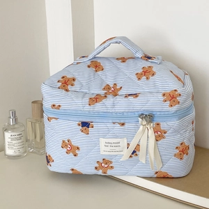 Blue striped quilted makeup bag with brown bear pattern and portable top handle