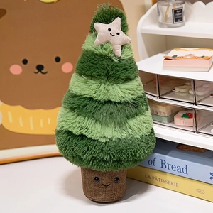 Christmas tree plush toy with cute star topper and smiling face in cozy setting