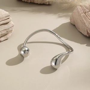 Macro shot of silver polished irregular metal choker with artistic geometric details