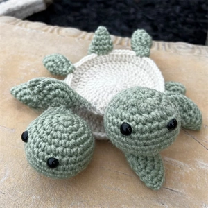 Macro detail of handmade crochet turtle coasters with intricate green stitch patterns