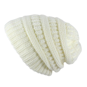Detail shot of chunky knit texture and soft beige yarn on a winter beanie hat