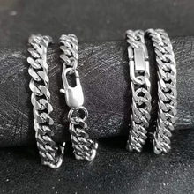 Macro detail of silver stainless steel Cuban chains with lobster and box clasps