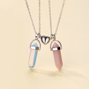 Magnetic couples necklace with hexagonal blue and pink stones on a beige background