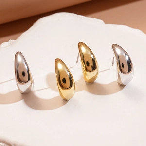 Polished double C-shaped teardrop stud earrings in gold and silver steel finish