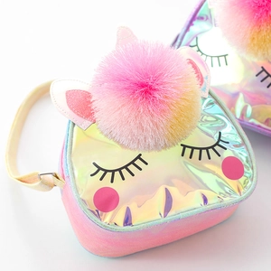 Detail of holographic unicorn crossbody bag with pink pompom and adjustable yellow strap