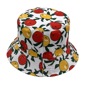 Detailed view of white cotton bucket hat featuring colorful orange and lemon fruit patterns