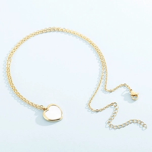 Detail of gold heart pendant with white enamel on a fine cable chain with lobster clasp
