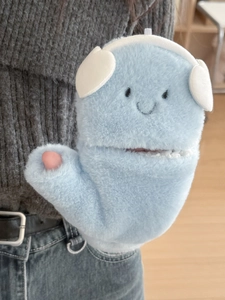 Close-up of light blue plush fingerless gloves with cute cartoon face and soft texture