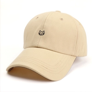 Detail of cute cat head embroidery on beige cotton twill baseball cap with reinforced brim