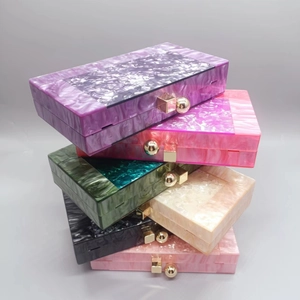 Stacked view of acrylic evening bags showing various marble textures and metal buckles