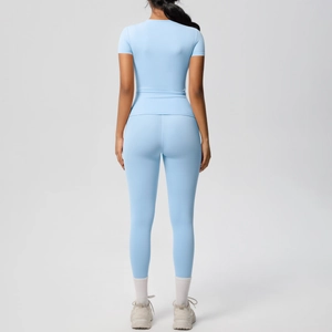 Light blue two-piece yoga set featuring a short sleeve top and high waist leggings from the back