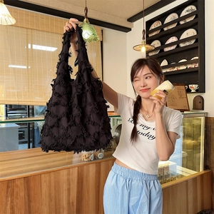Detail of black fringe canvas tote bag showing rich texture and large capacity for daily use