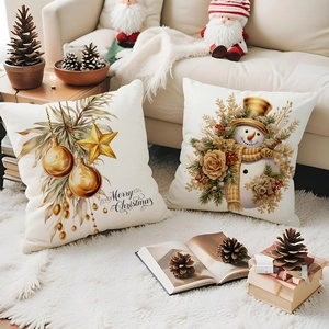 Detailed view of luxury Christmas pillow covers with gold festive prints and snowman