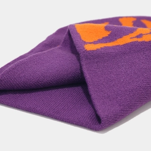 Detailed close-up of purple and orange Y2K knit beanie featuring jacquard texture