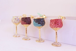 Detail of wine glass keychains in blue, pink, and purple colors with shiny rhinestones