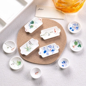 Miniature blue and white porcelain dinnerware set for dollhouse with floral patterns