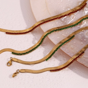 Detailed close-up of 18K gold-plated herringbone chains with red and green zircon stones