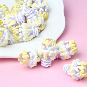 Macro shot of purple hand-painted acrylic ice cream beads with glossy pearlescent finish