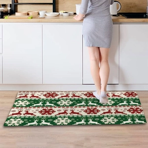 Detail of Christmas flannel floor mat with reindeer and snowflake patterns in a kitchen