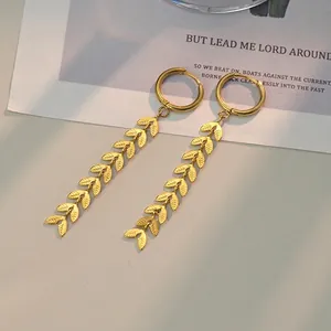 Golden fringe leaf drop earrings with wheat stalk pattern on vintage paper background