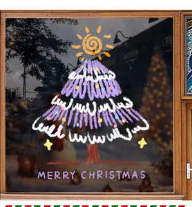 Detail of purple Christmas tree static sticker with Merry Christmas text on a glass window
