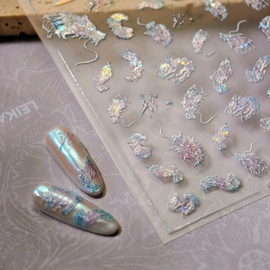Glittery 3D dragon nail art stickers with laser holographic effect on purple background
