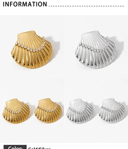 Detail showing polished gold and silver seashell jewelry set with white zircon inlay