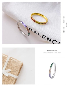 Detailed view of channel-set rainbow cubic zirconia on gold and silver ring bands