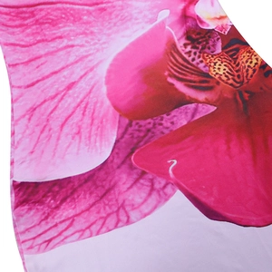 Close-up detail of the pink orchid print and polyester fabric texture on long dress