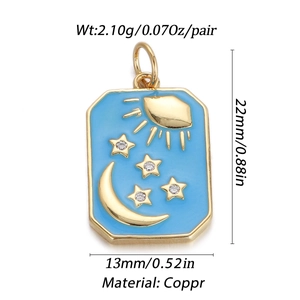 Detail view of gold rectangle charm with blue enamel moon and stars design and size specs