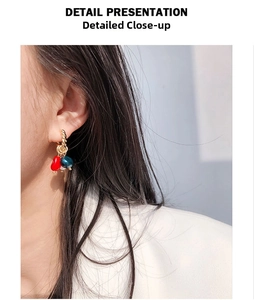 Detail presentation of gold braided hoops with colorful natural stone and pearl charms