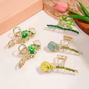 Detailed macro view of five Chinese-style floral hair clips with gold enamel finish