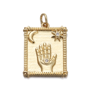 Detailed view of a gold Hamsa hand pendant with moon star patterns and cubic zirconia