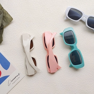 Flat lay of retro rectangle kids sunglasses with UV400 protection in assorted colors