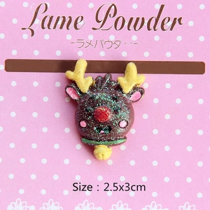 Macro detail of brown resin reindeer figurine with colorful sparkling glitter surface