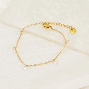 Detail of 18k gold plated stainless steel bracelet with teardrop zircon charms