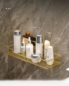 Close-up of golden bathroom storage rack with metal grid base for skin care organizers