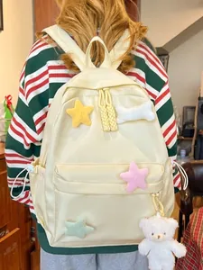 Minimalist yellow school backpack for students with plush stars and bear charm