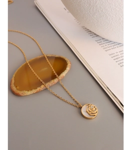 Detailed close-up of rose flower shell pendant on 18K gold plated necklace with zircon