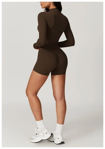 Detail of dark brown yoga set featuring high-waisted shorts with V-shaped back seam design