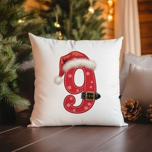Detailed view of a festive white Christmas cushion cover with red number nine and snowflakes