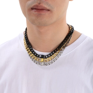 Three-layer stacked Cuban link necklaces in black, gold, and silver stainless steel finish